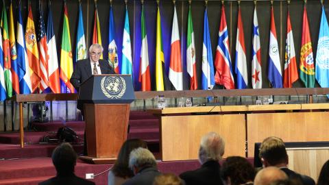 ECLAC Executive Secretary speaking in front of a podium in a conference room